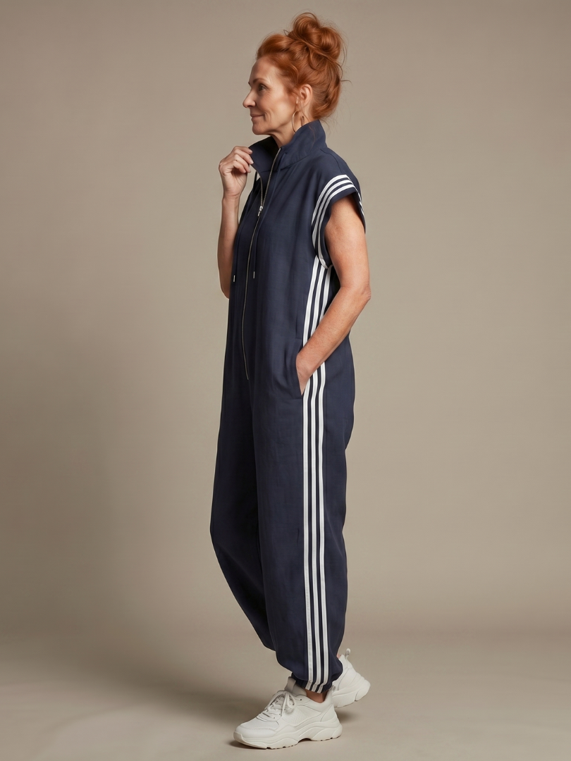 Navy zip-front sleeveless jumpsuit with white triple stripe side panels and cuffed legs
