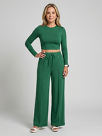 Green long-sleeve crop top and wide-leg pants set, drawstring waist.