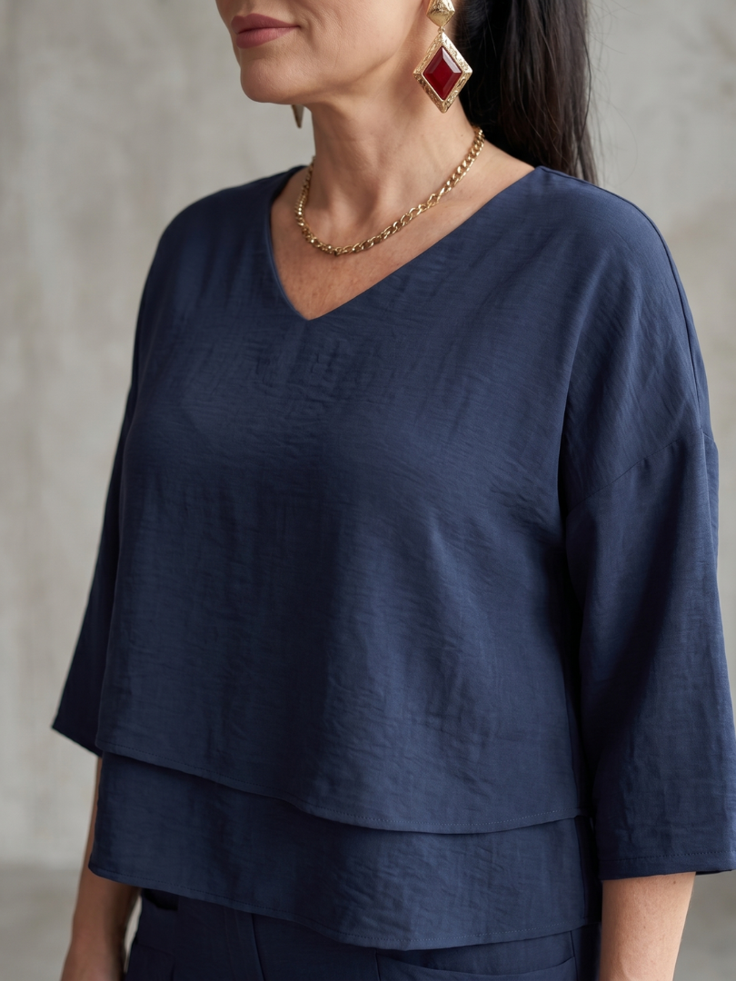 Navy layered V-neck top with three-quarter sleeves and double-tier hem