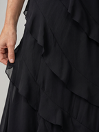 Layered ruffle detail on black spaghetti-strap maxi dress