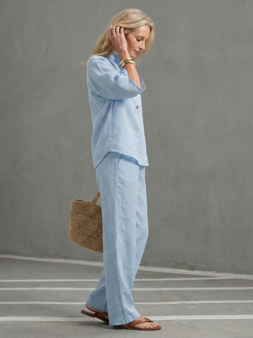 Sky blue button-front tunic with relaxed trousers, side view