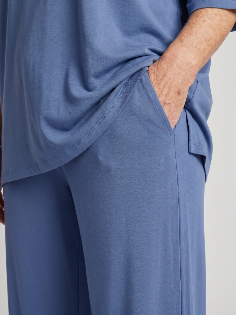 Blue wide-leg pants with side pocket detail and stitched seams