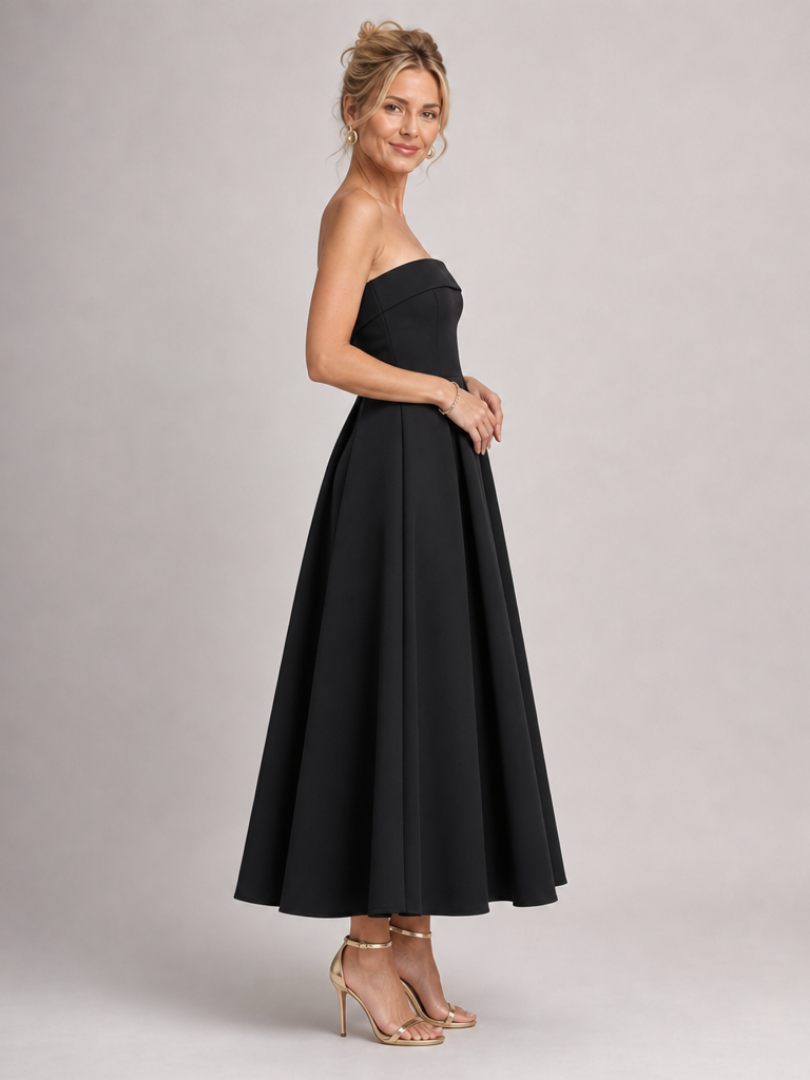 Black strapless structured bodice midi dress with pleated A-line skirt, side view