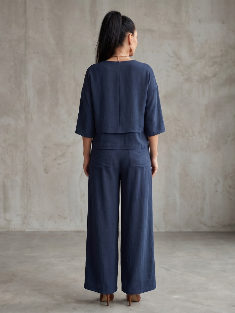 Navy layered top and wide-leg pants set, back view with tiered waist and legs