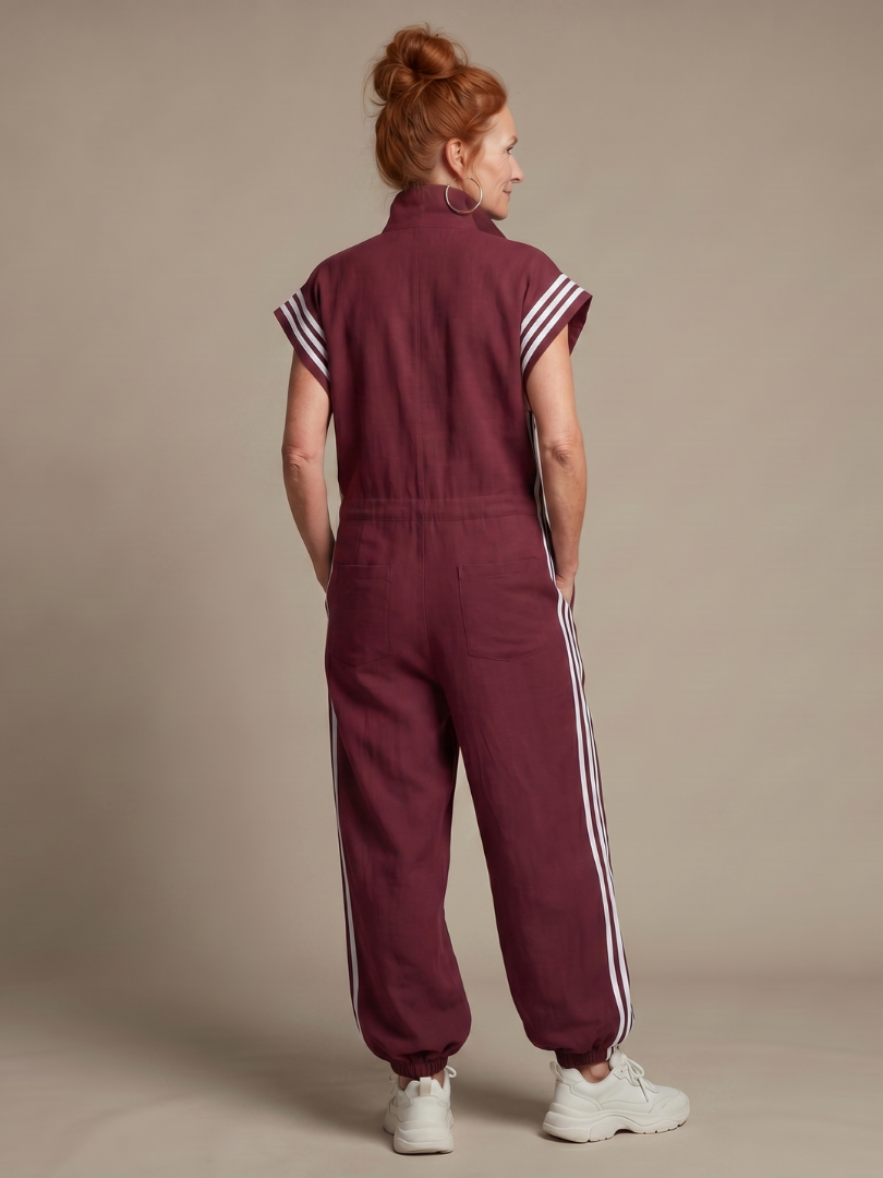 Burgundy zip-front jumpsuit, back view with white triple stripe detail and cuffed legs