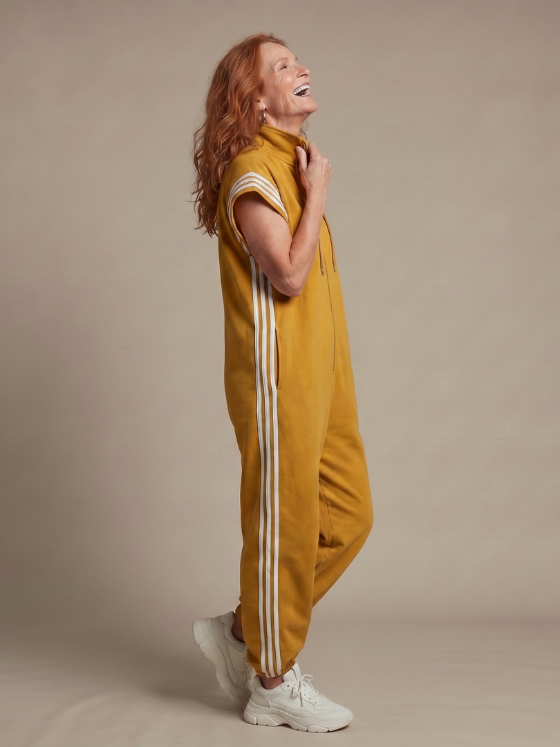 Yellow zip-front sleeveless jumpsuit, side view with white triple stripe panel trim
